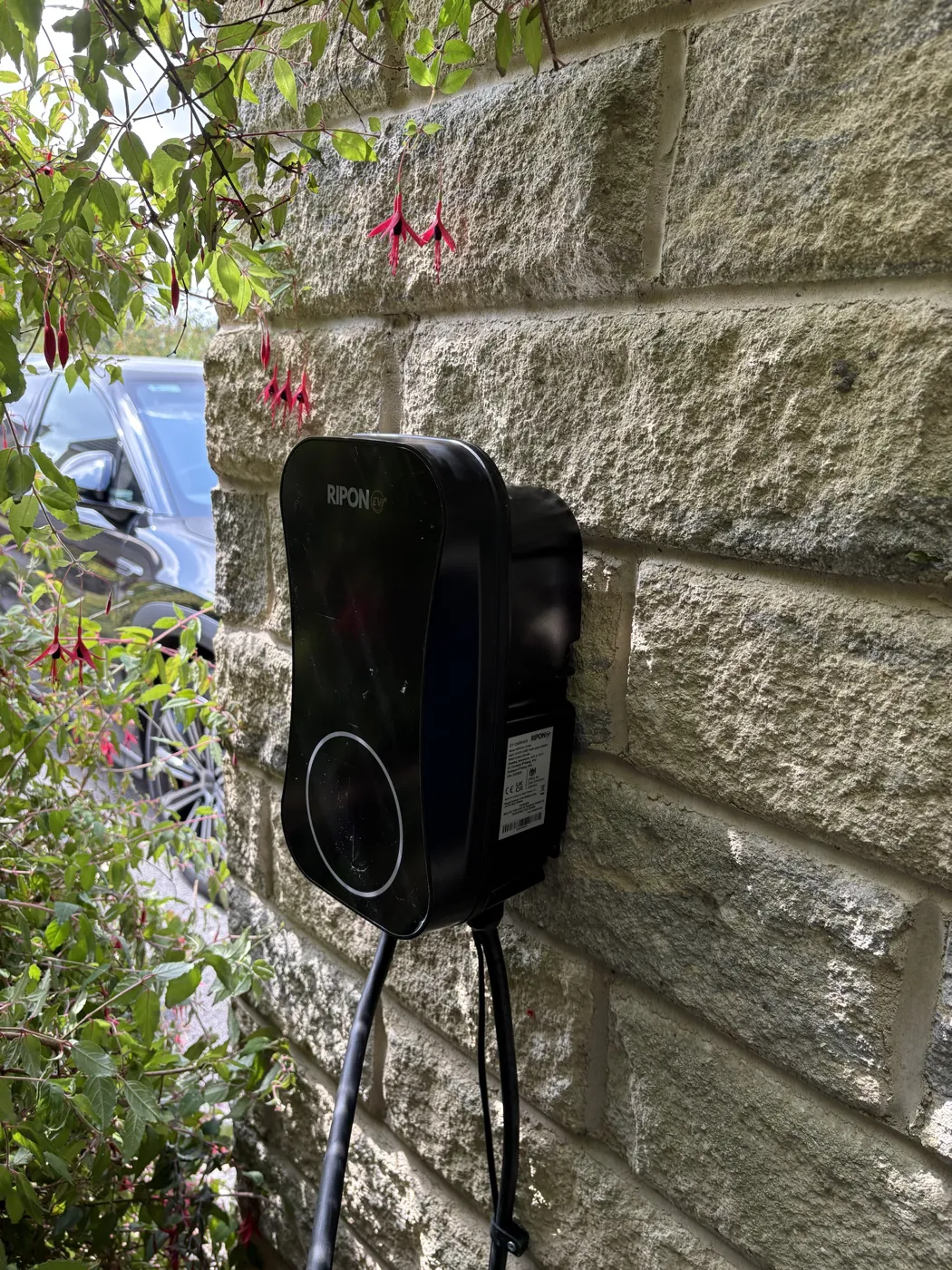 RiponEV charger on the side of a brick semi with the SmartWired van on the drive
