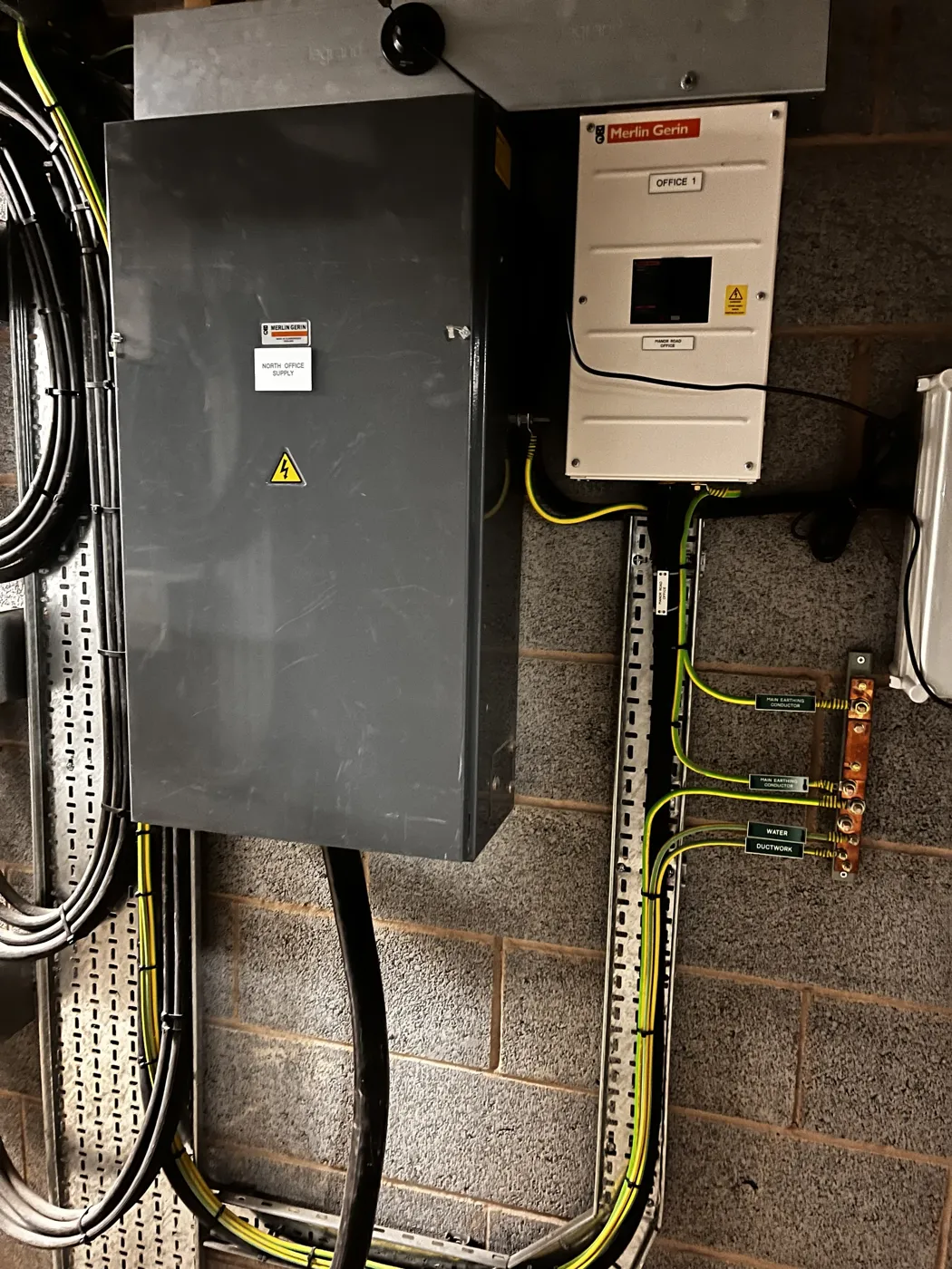 Commercial distribution board with labelled main earthing bar and cable tray