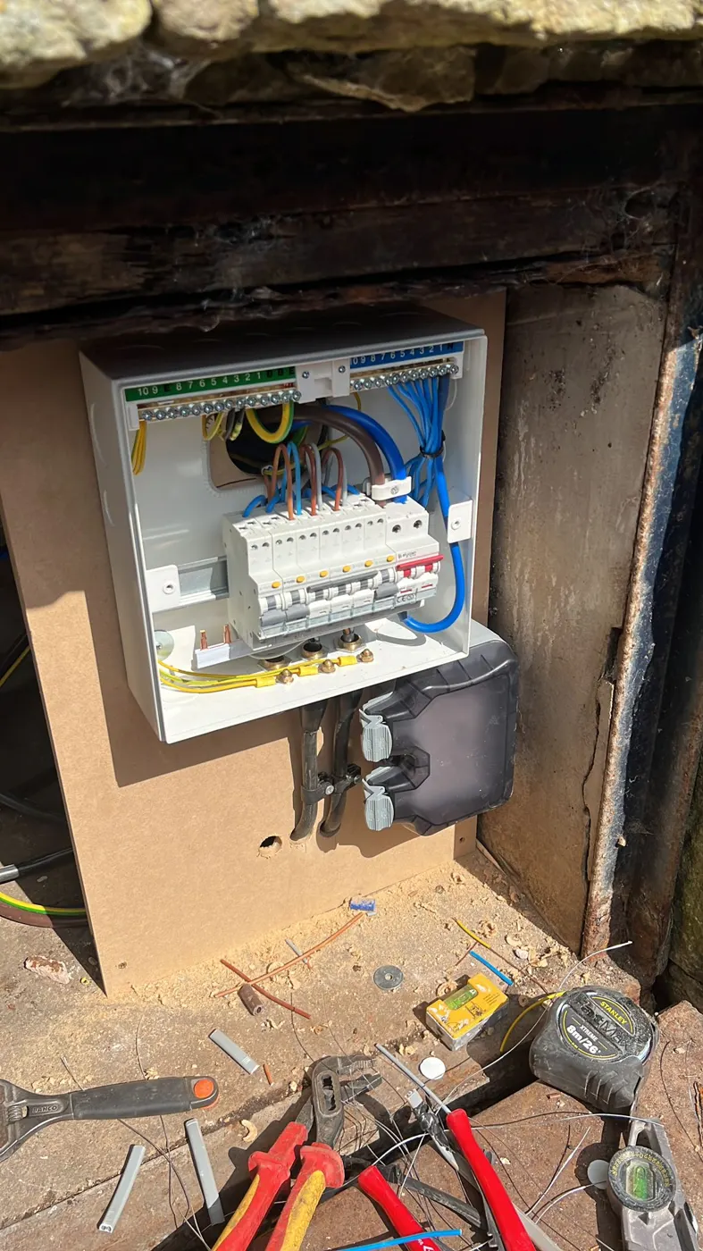 New consumer unit wired neatly in a stone meter cupboard