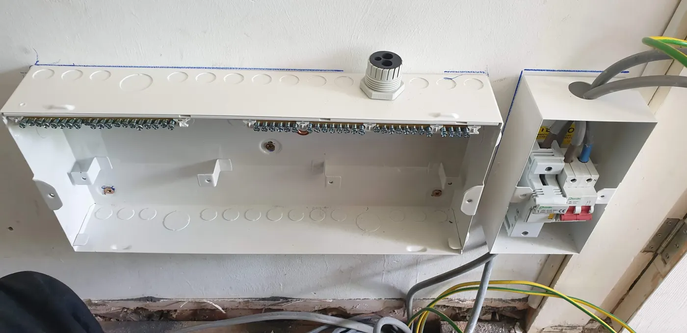 New metal consumer unit enclosure and isolator fixed to the wall