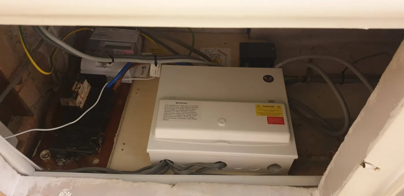 Finished Verso consumer unit with cover on, in a meter cupboard with solar PV