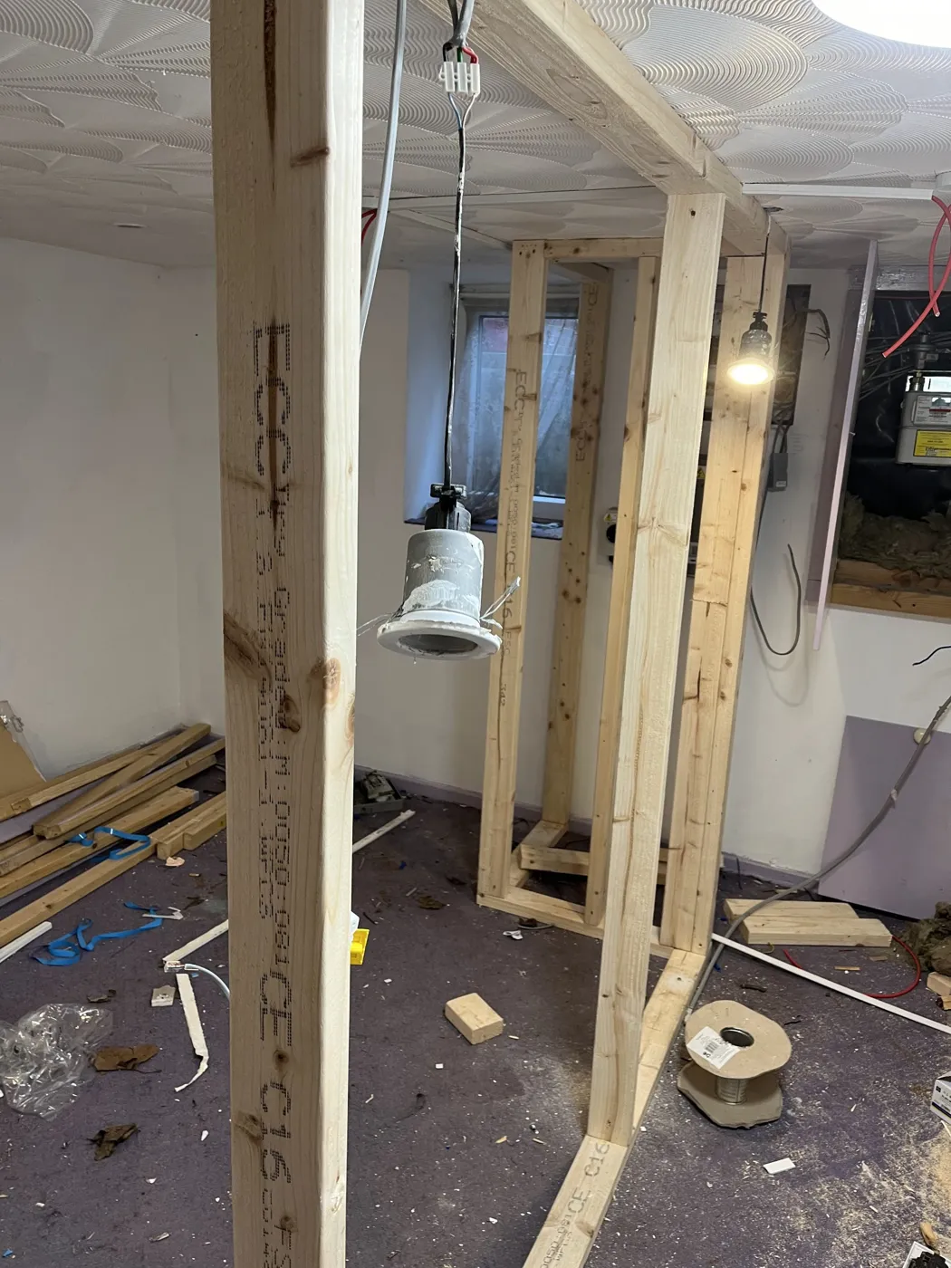New stud walls with lighting cables and a downlight ready for second fix