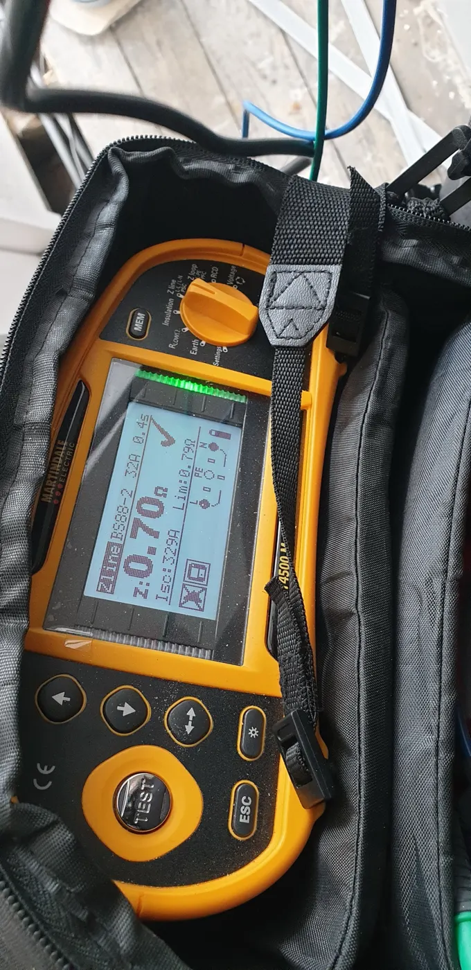 Multifunction tester showing a passing earth loop impedance reading