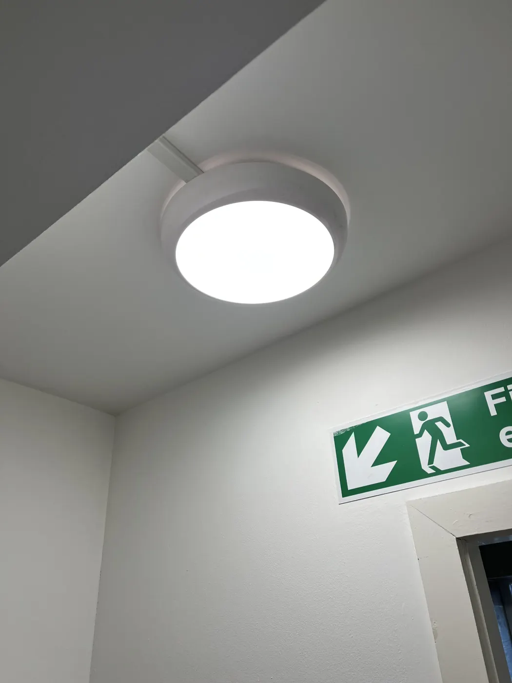 Emergency light above a fire exit sign