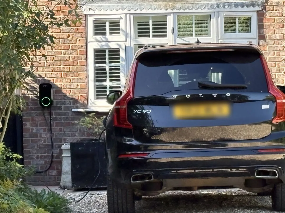 Home EV charger beside a Volvo XC90