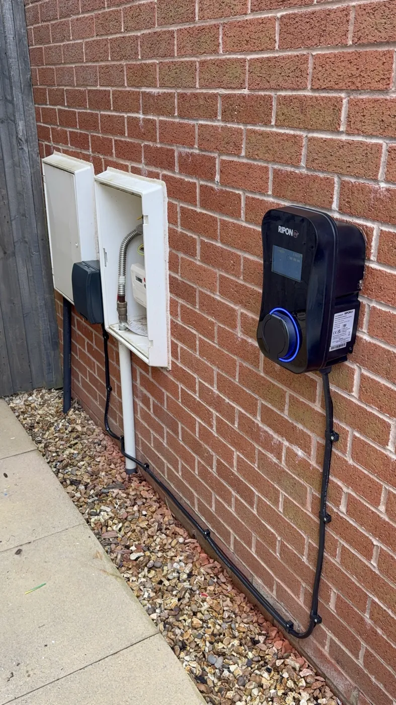 RiponEV display charger with the supply run low along the wall from the meter boxes