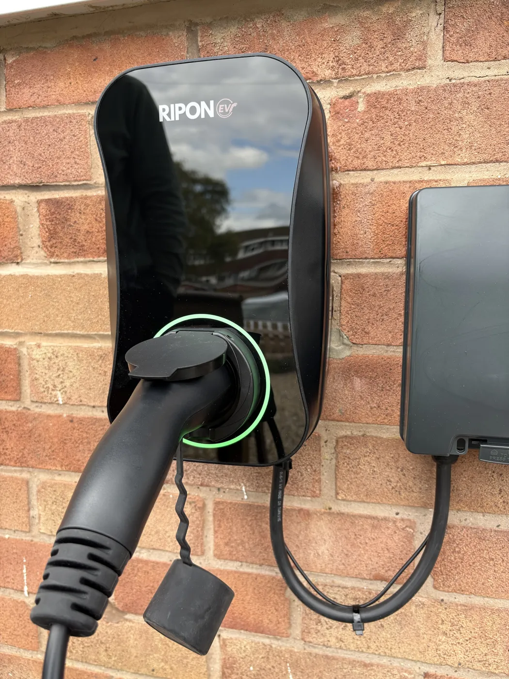 RiponEV charger with a Type 2 cable plugged in and green ring lit