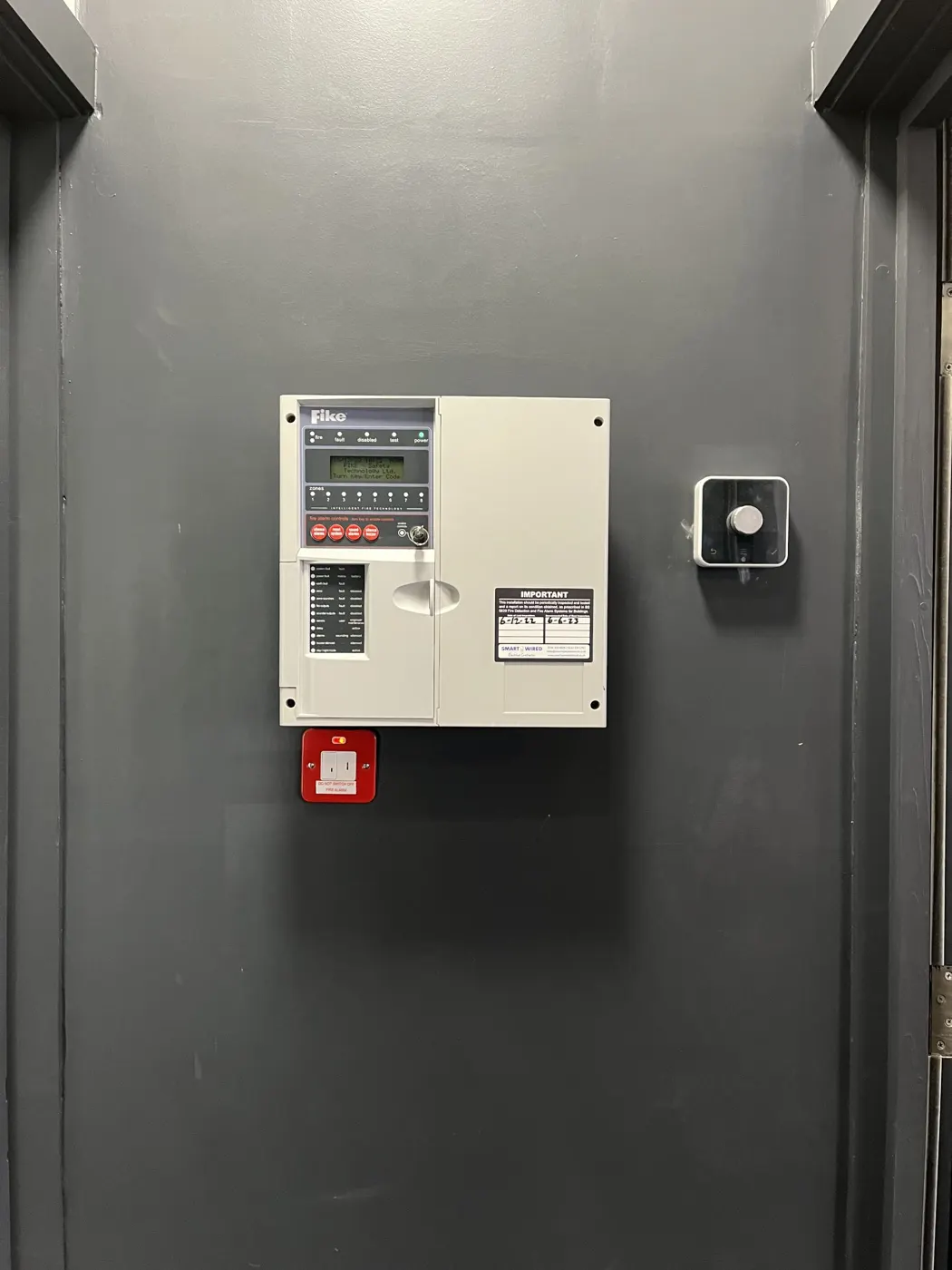 Fire alarm panel with SmartWired service label