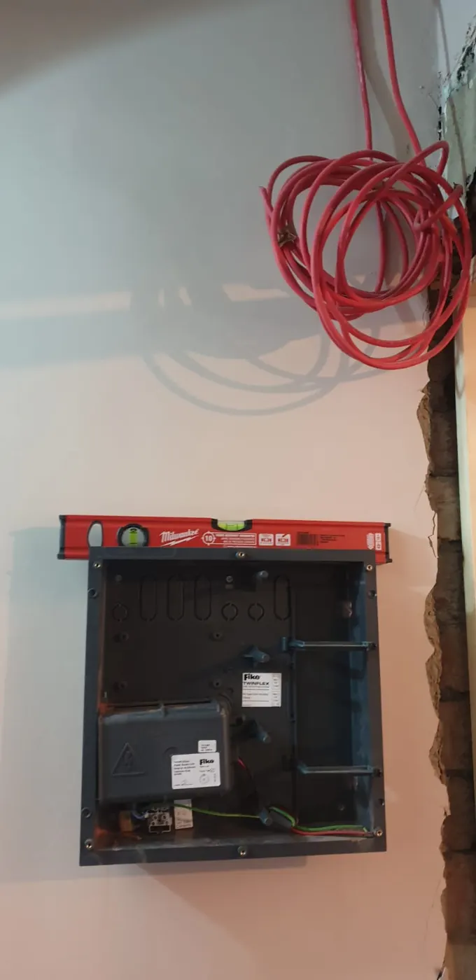 Fire alarm panel back box levelled on the wall with fire-resistant cable ready