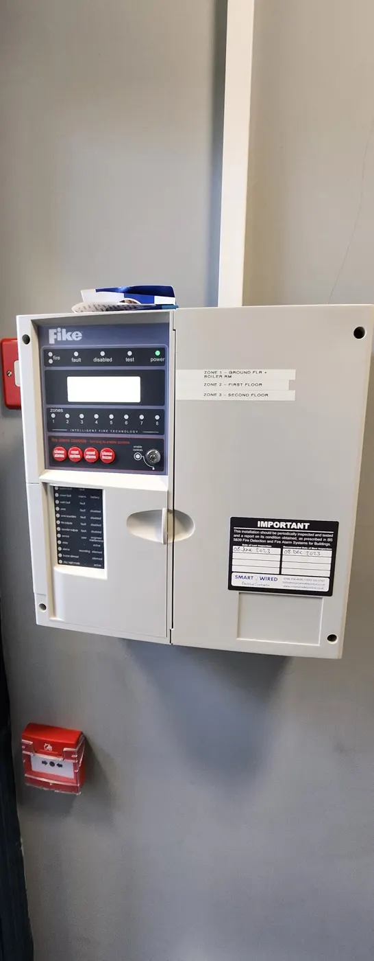 Fire alarm panel with SmartWired service label