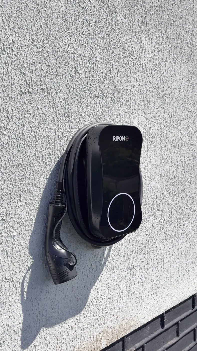 RiponEV charger on white render above a dark brick plinth
