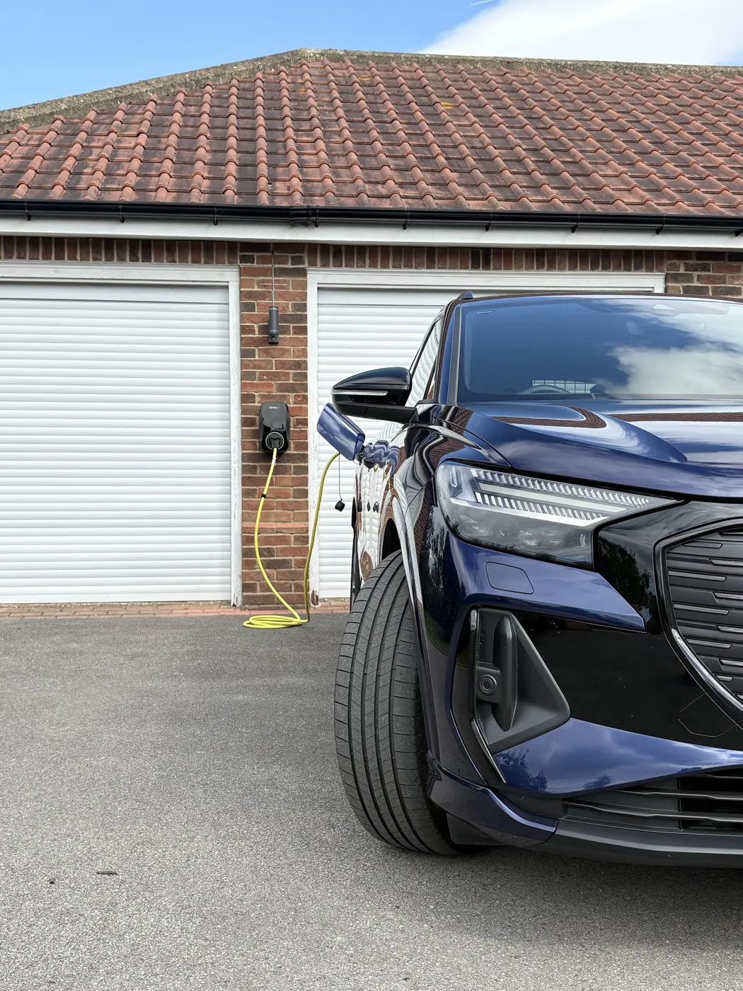 Audi Q4 e-tron charging from a RiponEV charger fitted between two garage doors in Harrogate