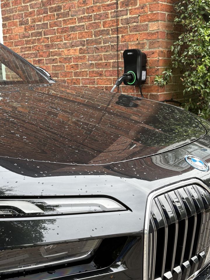 EV charger on a brick wall charging a BMW