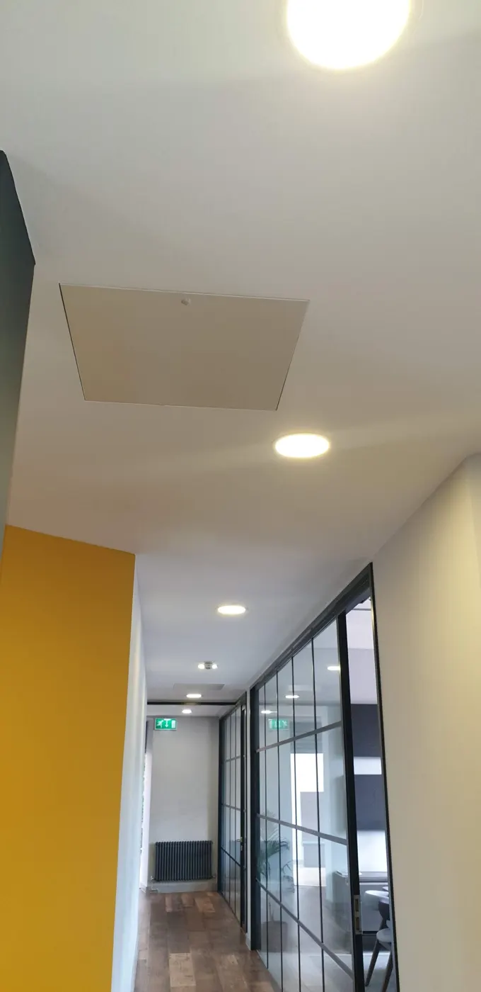 Office corridor with downlights and exit signs