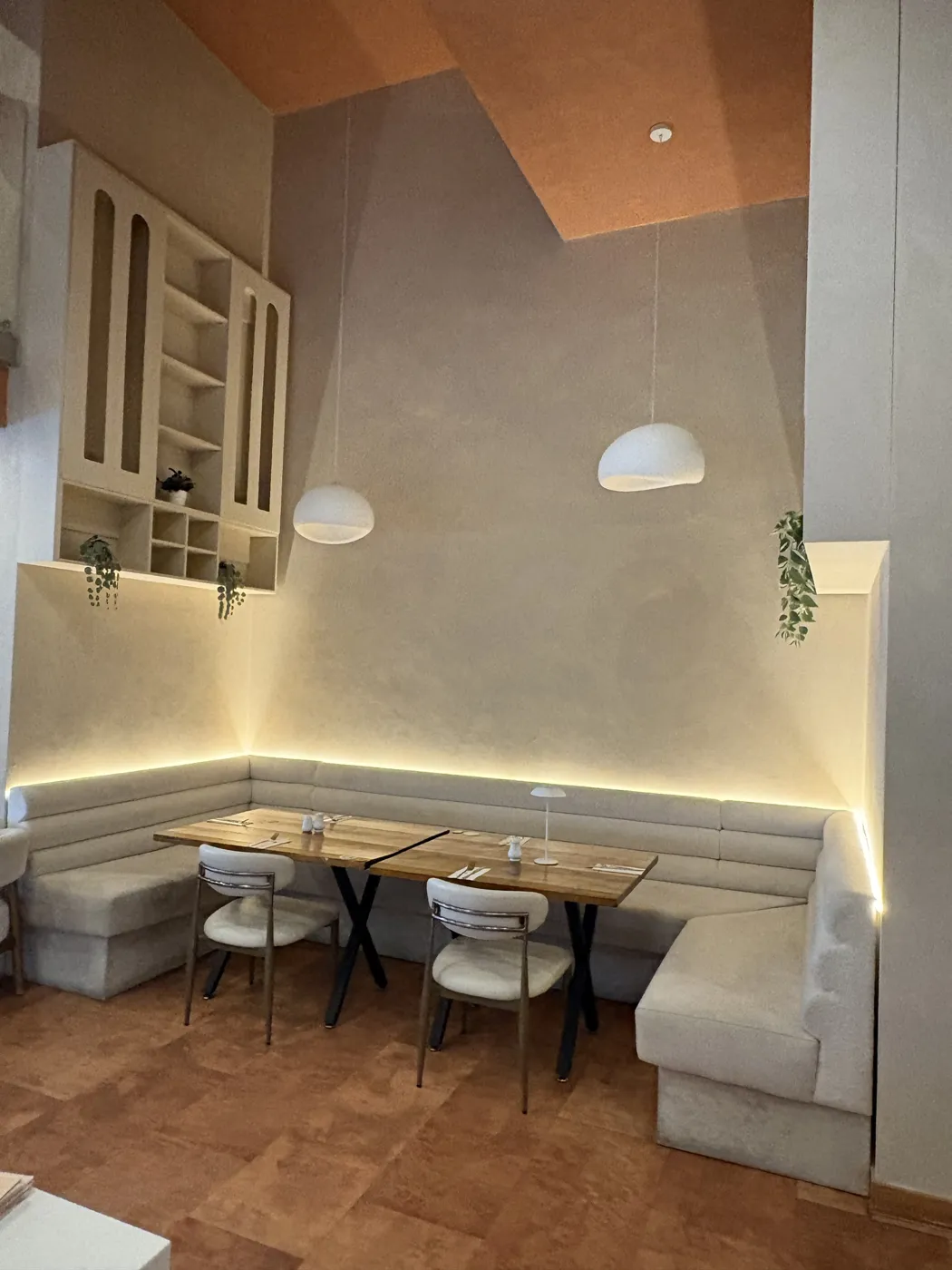Restaurant booth with LED strip lighting and pendant lights