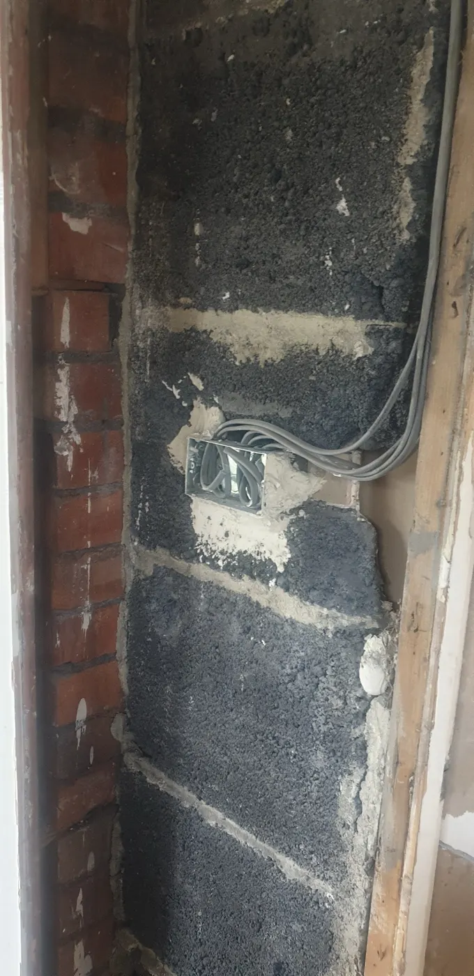 Metal back box set into blockwork with cables