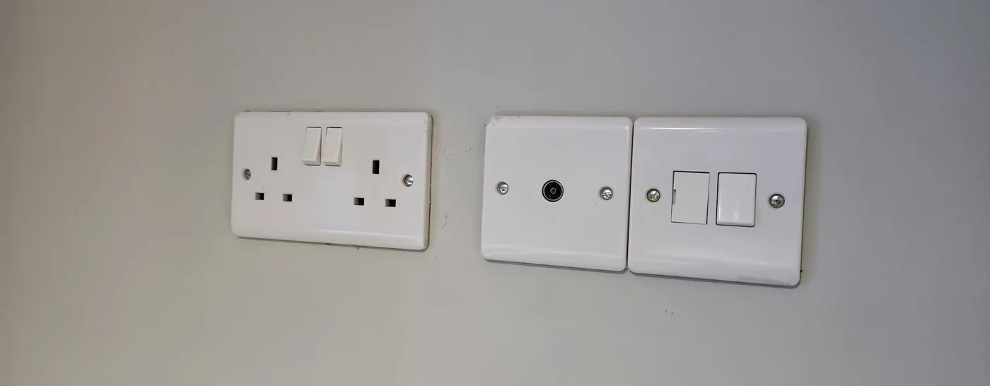 Finished double socket, TV point and fused spur on a painted wall