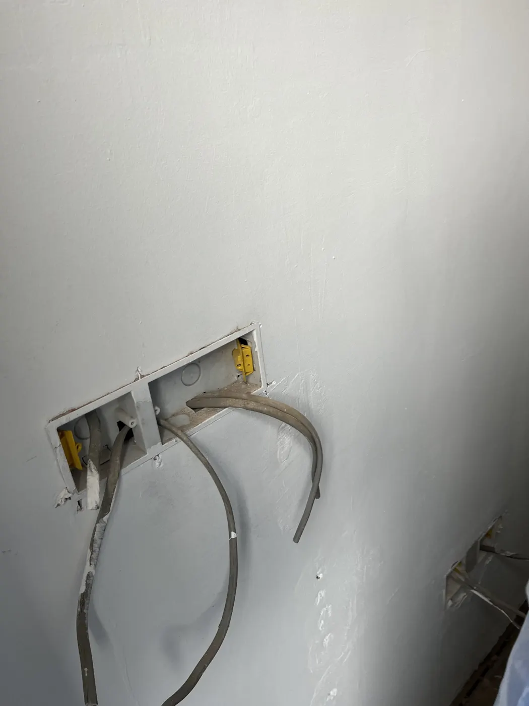 New back boxes chased into a wall with cables ready for second fix