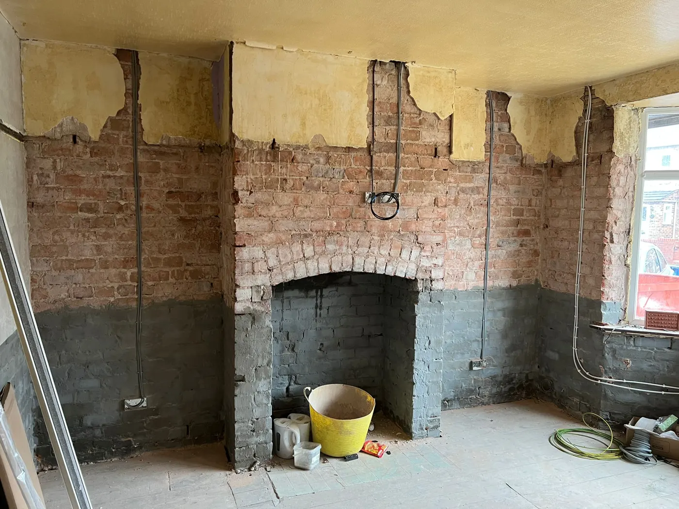 Living room stripped back to brick with new cables run to every socket and light position during a full rewire