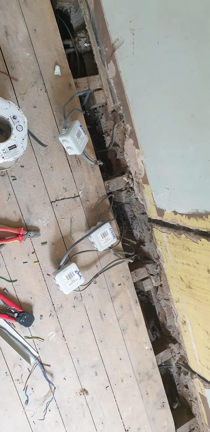 Labelled junction boxes under lifted floorboards