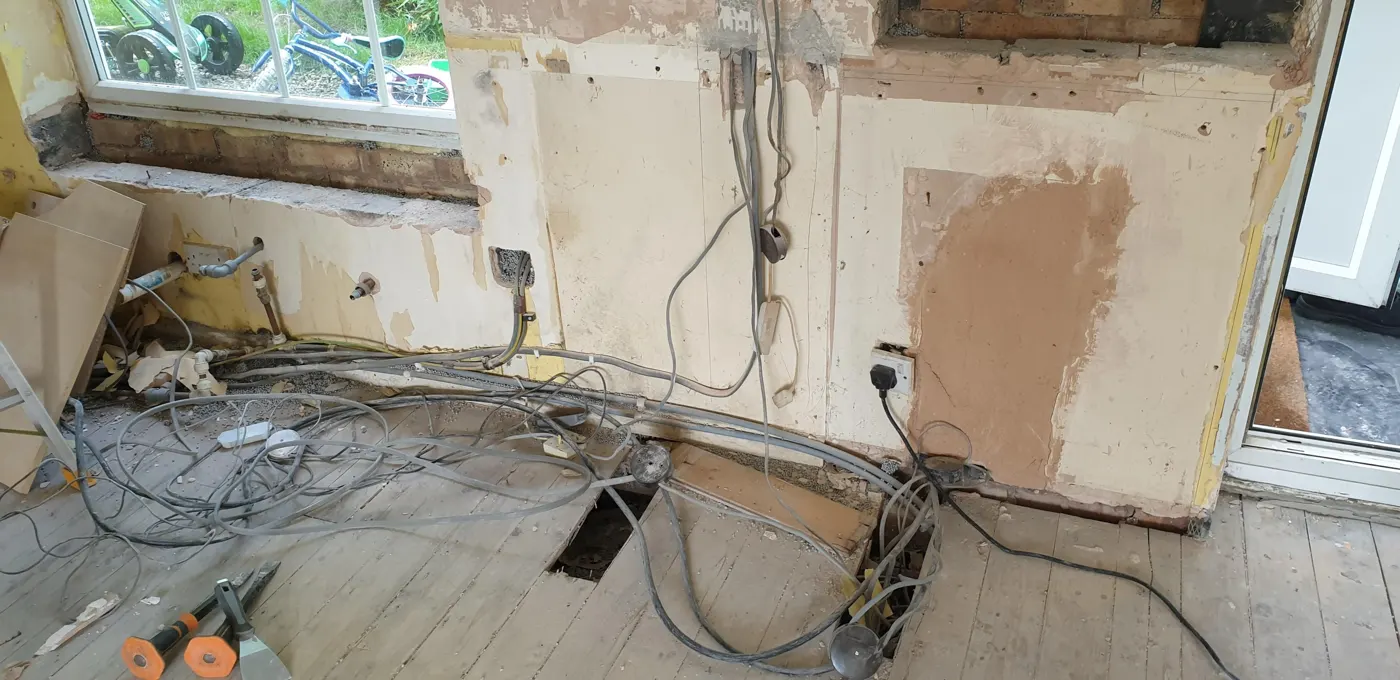 Old kitchen wiring and loose cables before a rewire