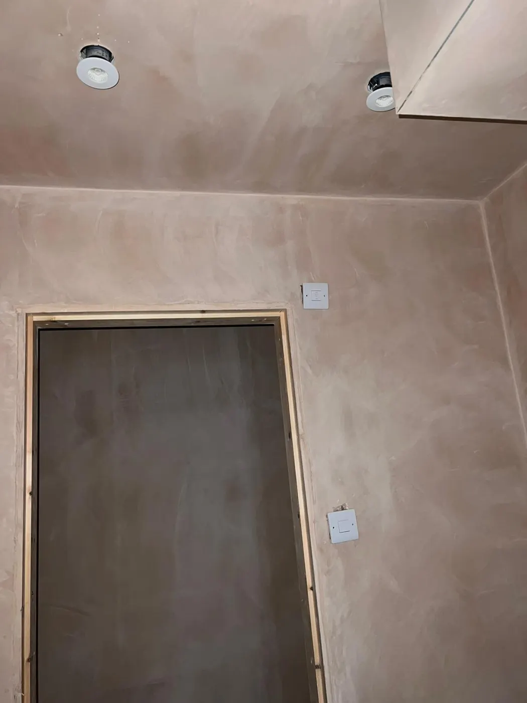 New downlights and switches fitted in a freshly plastered room