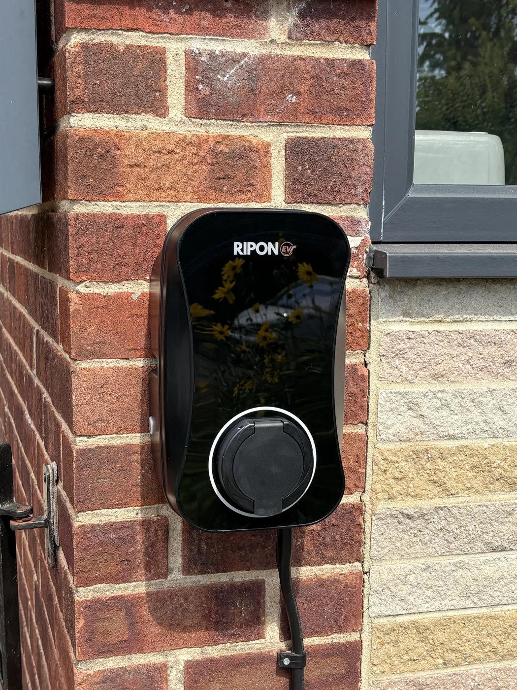 RiponEV charger on the brick corner of a Sheffield home beside stone cladding