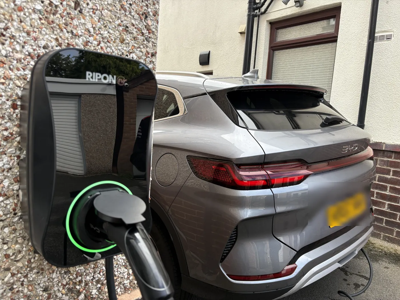 BYD plugged into a RiponEV charger on a pebbledashed Sheffield house