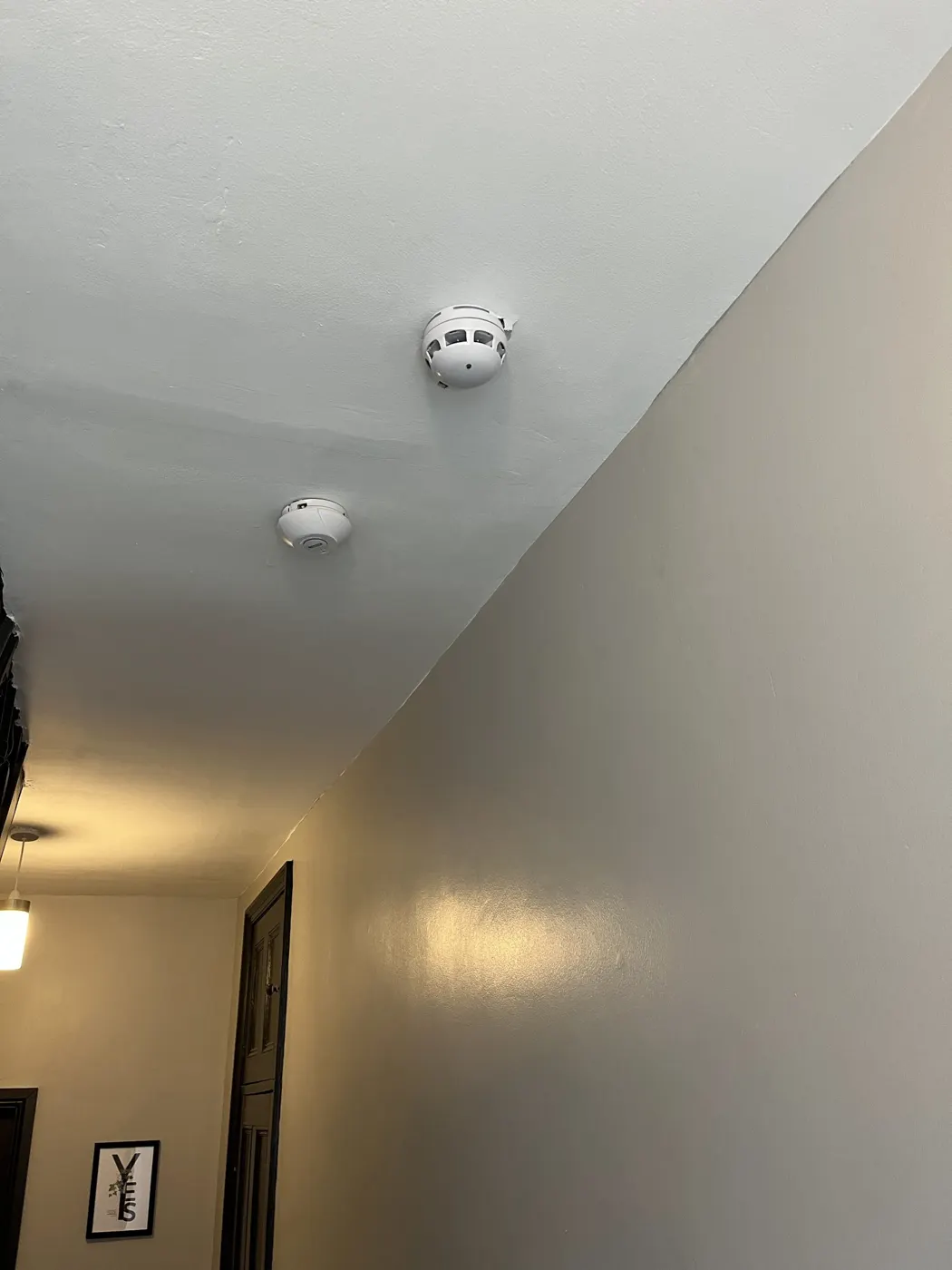 Smoke and heat detectors fitted to a hallway ceiling